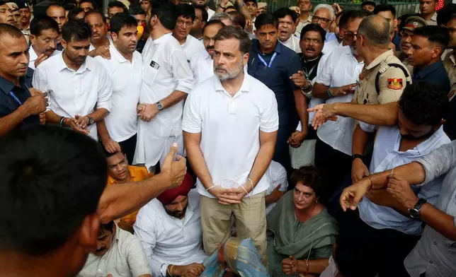 India's opposition Congress party leader Rahul Gandhi, center, with his hands tied, participates in a sit-in protest with his sister and lawmaker Priyanka Gandhi Vadra, center right, outside the residence of Prime Minister Narendra Modi in New Delhi, India, Tuesday, July 21, 2026. (AP Photo/Shekhar Yadav)