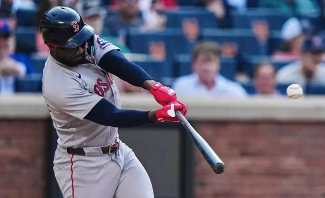 Boston Red Sox's Andruw Monasterio hits a two-run home run during the fourth inning of a baseball game against the New York Mets Saturday, July 11, 2026, in New York. (AP Photo/Frank Franklin II)