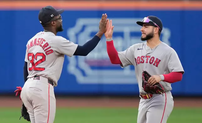 Boston Red Sox's Andruw Monasterio, left, celebrates with Wilyer Abreu after of a baseball game against the New York Mets Saturday, July 11, 2026, in New York. (AP Photo/Frank Franklin II)