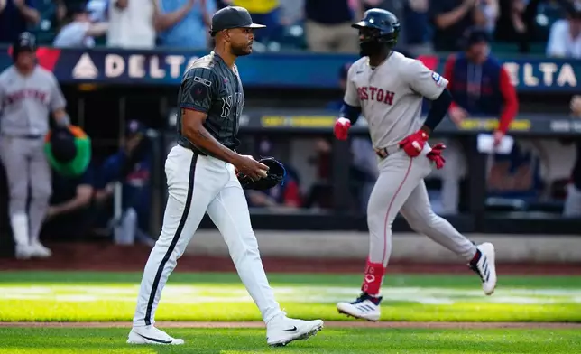New York Mets pitcher Freddy Peralta, left, reacts as Boston Red Sox's Andruw Monasterio runs the bases after hitting a two-run home run during the fourth inning of a baseball game Saturday, July 11, 2026, in New York. (AP Photo/Frank Franklin II)