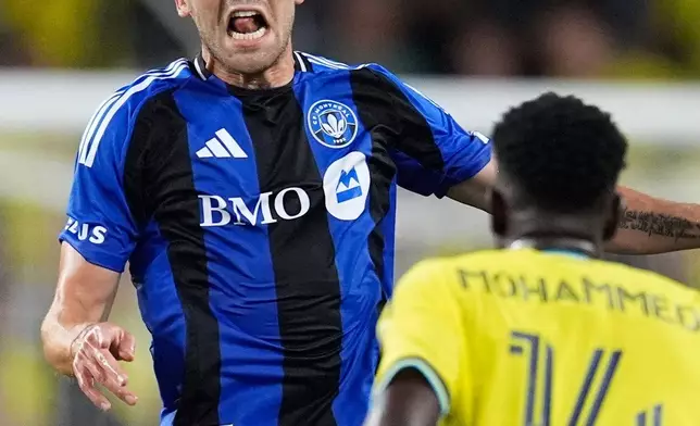 CF Montréal defender Luca Petrasso (13) heads the ball over Nashville SC midfielder Shakur Mohammed (14) during the first half of an MLS soccer match Wednesday, July 22, 2026, in Nashville, Tenn. (AP Photo/George Walker IV)