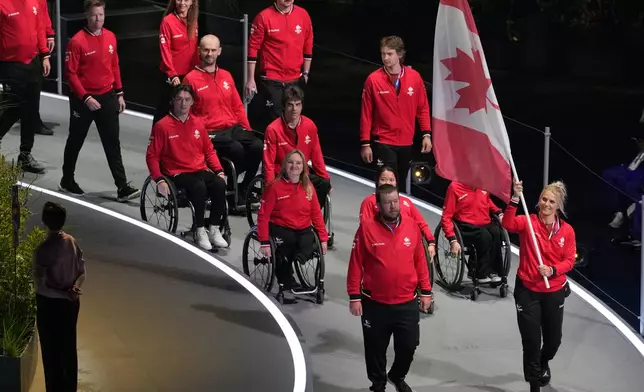 The Canadian team arrives during the Commonwealth Games opening ceremony in Glasgow, Scotland, Thursday, July 23, 2026. (AP Photo/Manish Swarup)
