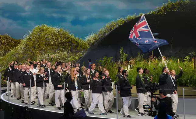 The team from New Zealand arrives onstage during the Commonwealth Games opening ceremony in Glasgow, Scotland, Thursday, July 23, 2026. (AP Photo/Kin Cheung)