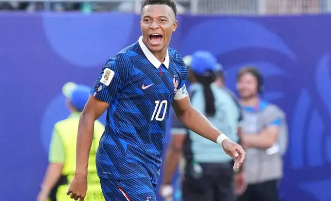 France's Kylian Mbappe (10) celebrates after scoring from a penalty kick the opening goal during the World Cup round of 16 soccer match between Paraguay and France in Philadelphia, Saturday, July 4, 2026. (AP Photo/Martin Meissner)