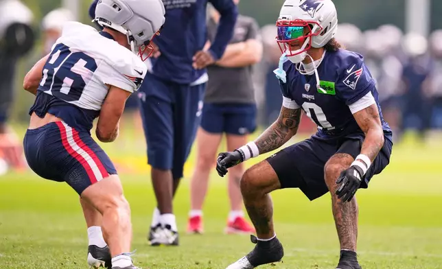 New England Patriots cornerback Christian Gonzalez, right, defends against Efton Chism III (86) during the team's NFL football training camp, Tuesday, July 28, 2026, in Foxborough, Mass. (AP Photo/Charles Krupa)