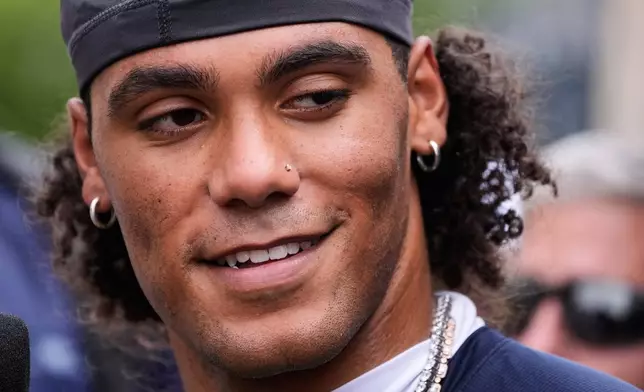 New England Patriots cornerback Christian Gonzalez listens to a reporter's question during the team's NFL football training camp, Tuesday, July 28, 2026, in Foxborough, Mass. (AP Photo/Charles Krupa)