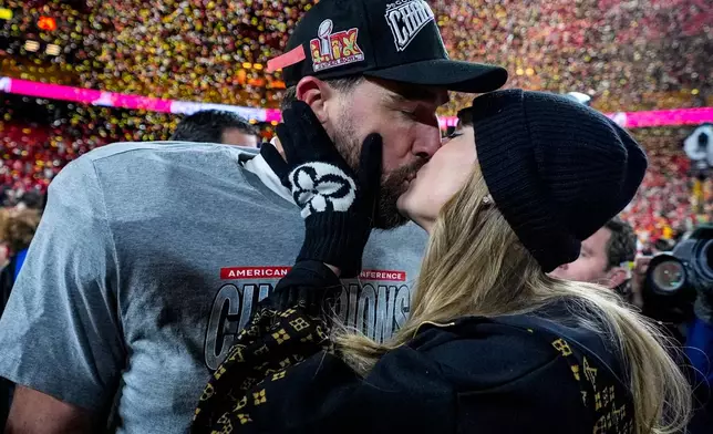 FILE - Kansas City Chiefs tight end Travis Kelce and Taylor Swift kiss after the AFC Championship NFL football game against the Buffalo Bills, Jan. 26, 2025, in Kansas City, Mo. (AP Photo/Ashley Landis, File)