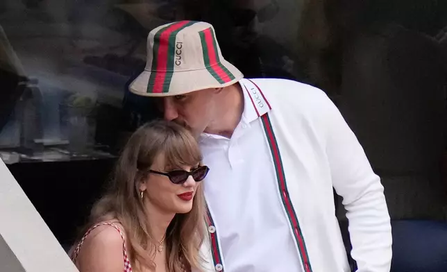 FILE - Taylor Swift gets a kiss from Kansas City Chiefs' Travis Kelce as they arrive to watch the men's singles final of the U.S. Open tennis championships in New York on Sept. 8, 2024. (AP Photo/Frank Franklin II, File)