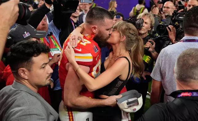 FILE - Kansas City Chiefs tight end Travis Kelce (87) kisses Taylor Swift after the Kansas City Chiefs defeated the San Francisco 49ers at the Super Bowl in Las Vegas on Feb. 11, 2024. (AP Photo/John Locher, File)