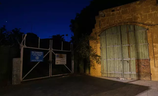 A gate used by U.N peacekeepers separates the Greek Cypriot south from the Turkish Cypriot north along the U.N.-controlled buffer zone, established after the July 20, 1974 Turkish invasion of Cyprus, in the medieval core of the divided capital, Nicosia, Cyprus, on July 7, 2026. (AP Photo/Petros Karadjias)