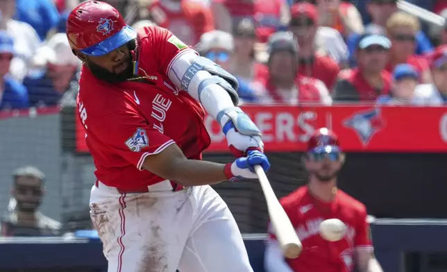 Toronto Blue Jays' Vladimir Guerrero Jr. hits a double off of New York Mets pitcher Freddy Peralta during first inning MLB baseball action in Toronto on Wednesday, July 1, 2026. (Frank Gunn/The Canadian Press via AP)