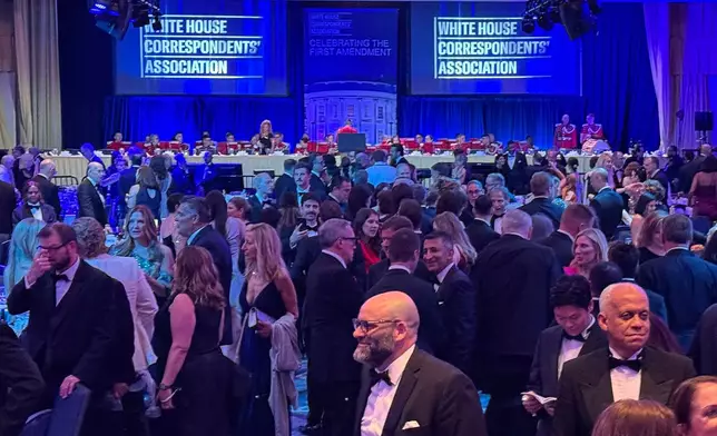 FILE - Attendees gather during White House Correspondents Association Dinner prior to a security incident, April 25, 2026, in Washington. (AP Photo/Mark Schiefelbein, File)