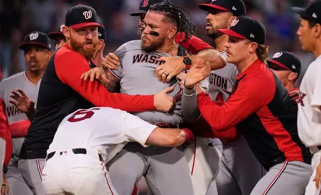 Washington Nationals' Andrés Chaparro, center, is held back as tempers flare during the fourth inning of a baseball game against the Boston Red Sox, Tuesday, June 30, 2026, in Boston. (AP Photo/Charles Krupa)