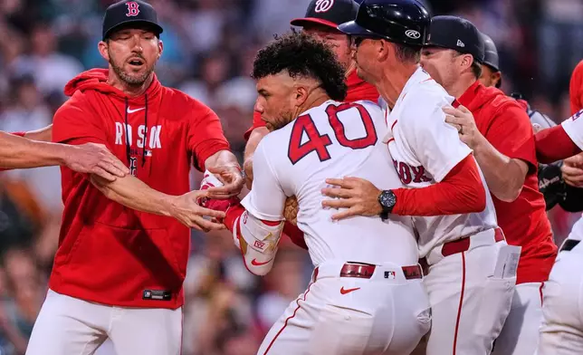 Boston Red Sox's Willson Contreras (40) is held back as tempers flare during the fourth inning of a baseball game against the Washington Nationals, Tuesday, June 30, 2026, in Boston. (AP Photo/Charles Krupa)