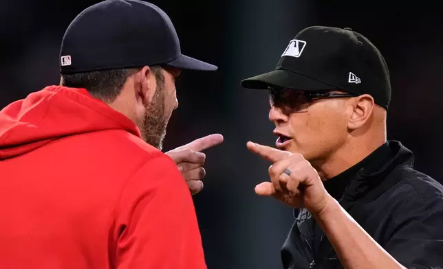 Boston Red Sox interim manager Chad Tracy, left, argues with umpire Vic Carapazza following a bench clearing altercation during the fourth inning of a baseball game against the Washington Nationals, Tuesday, June 30, 2026, in Boston. (AP Photo/Charles Krupa)