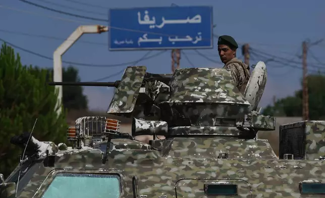 A Lebanese soldier stands atop an armored personnel carrier while manning a checkpoint at the entrance to Srifa village in southern Lebanon, Tuesday, July 21, 2026. (AP Photo/Hassan Ammar)