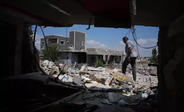 A resident inspects the damage to his home, destroyed in an Israeli airstrike during the Israel-Hezbollah war in Ghandouriyeh village, southern Lebanon, Tuesday, July 21, 2026. (AP Photo/Hassan Ammar)