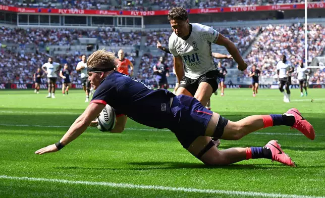 England's Henry Pollock scores a try during the Nations Championship rugby match between England and Fiji in Liverpool, England, Saturday, July 11, 2026. (Bruce Rollinson/PA via AP)