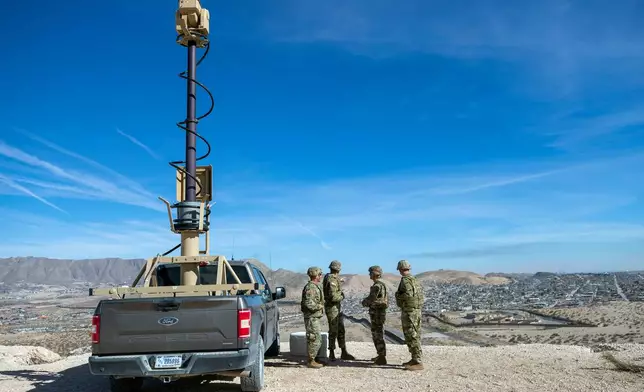 FILE - Army soldiers look at the border wall next to a surveillance vehicle during the visit to the U.S. and Mexico border by Defense Secretary Pete Hegseth in Sunland Park, N.M., Feb. 3, 2025. (AP Photo/Andres Leighton, File)