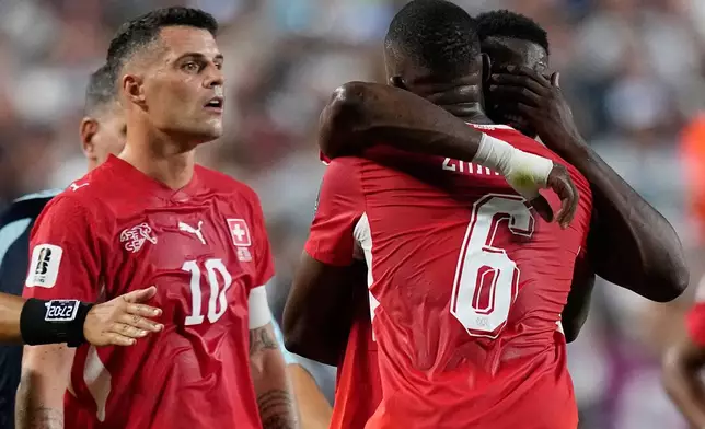 Switzerland's Breel Embolo, right, is consoled by teammate Denis Zakaria (6) after he was given a red card during the World Cup quarterfinal soccer match between Argentina and Switzerland in Kansas City, Mo., Saturday, July 11, 2026. (AP Photo/Ashley Landis)