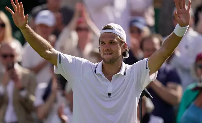 Otto Virtanen of Finland celebrates winning against Ben Shelton of the United States after their men's singles match at the Wimbledon Tennis Championships in London, Tuesday, June 30, 2026.(AP Photo/Brian Inganga)