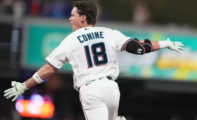 Miami Marlins' Griffin Conine (18) reacts after hitting a walk off single to score Heriberto Hernández and defeat the Philadelphia Phillies in the the ninth inning of a baseball game, Monday, July 27, 2026, in Miami. (AP Photo/Lynne Sladky)