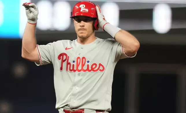 Philadelphia Phillies' J.T. Realmuto reacts after hitting a double to score two runs during the sixth inning of a baseball game against the Miami Marlins, Monday, July 27, 2026, in Miami. (AP Photo/Lynne Sladky)