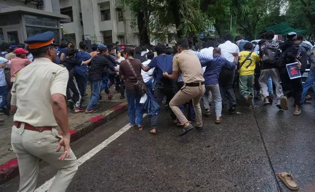 Police officers chase protesters during a demonstration demanding educational reforms as part of the Cockroach Janta Party's ongoing protest movement in Mumbai, India, Thursday, July 23, 2026. (AP Photo/Rafiq Maqbool)