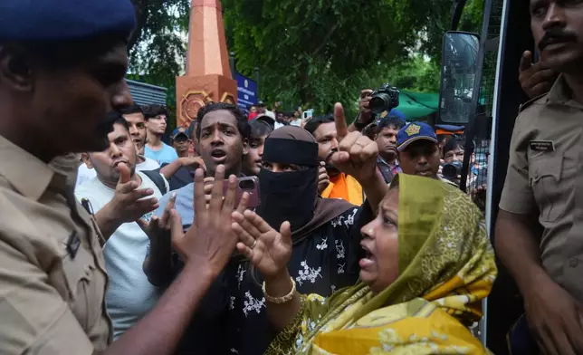 Protesters confront a police officer during a demonstration demanding educational reforms as part of the Cockroach Janta Party's ongoing protest movement in Mumbai, India, Thursday, July 23, 2026. (AP Photo/Rafiq Maqbool)