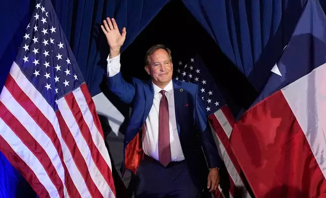 FILE - Texas Attorney General Ken Paxton, a Republican candidate for the U.S. Senate, waves as he takes the stage during a primary runoff election night event after winning the Republican party's nomination, May 26, 2026, in Plano, Texas. (AP Photo/Tony Gutierrez, File)