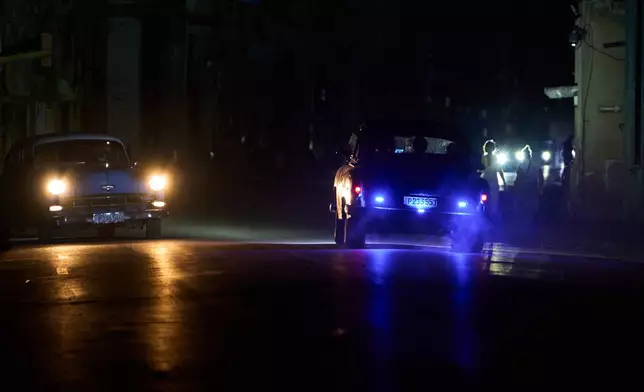 People drive American classic cars during a blackout in Havana, Cuba, Friday, July 10, 2026. (AP Photo/Ramon Espinosa)