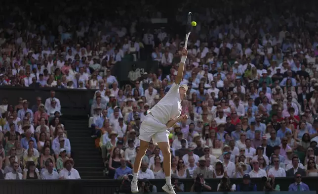 Jannik Sinner of Italy serves to Novak Djokovic of Serbia in their men's singles semifinal match at the Wimbledon Tennis Championships in London, Friday, July 10, 2026. (AP Photo/Brian Inganga)