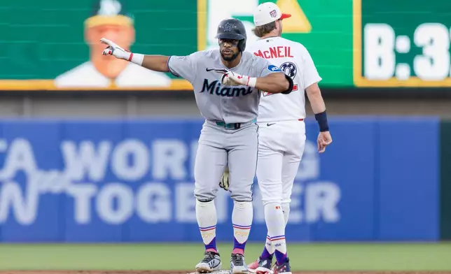 Miami Marlins' Otto Lopez celebrates an RBI double during the fifth inning of a baseball game against the Athletics Saturday, July 4, 2026, in West Sacramento, Calif. (AP Photo/Sara Nevis)