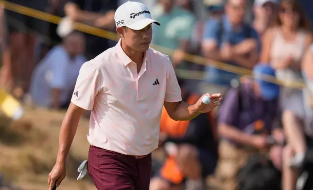 Collin Morikawa of the United States acknowledges the crown on the 1st green after putting during the second day of the British Open Golf championships at Royal Birkdale golf club, in Southport, England, Friday, July 17, 2026. (AP Photo/David Goldman)