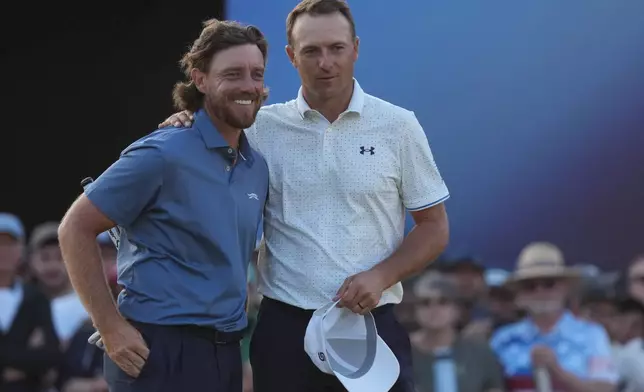 Tommy Fleetwood of England, left with Jordan Spieth of the United States on the 18th green after they completed their second rounds during the second day of the British Open Golf championships at Royal Birkdale golf club, in Southport, England, Friday, July 17, 2026. (AP Photo/Jon Super)