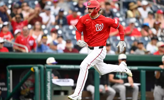 Washington Nationals' Brady House scores a run on a Nationals' Jacob Young RBI single during the second inning of a baseball game against the Arizona Diamondbacks, Sunday, July 26, 2026, in Washington. (AP Photo/John McDonnell)