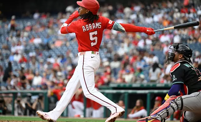 Washington Nationals' CJ Abrams hits a solo home run during the third inning of a baseball game against the Arizona Diamondbacks, Sunday, July 26, 2026, in Washington. (AP Photo/John McDonnell)