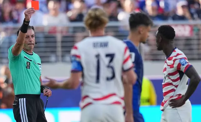 Referee Raphael Claus of Brazil shows a red card to United States' Folarin Balogun, right, during the World Cup round of 32 soccer match between the United States and Bosnia in Santa Clara, Calif., near San Francisco, Wednesday, July 1, 2026. (AP Photo/Julio Cortez)