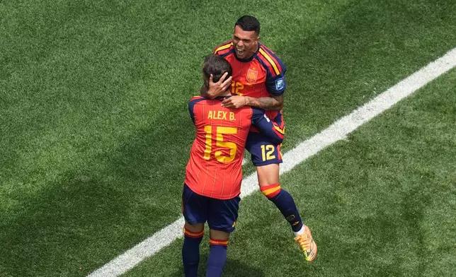 Spain's Pedro Porro (12) celebrates scoring his side's 2nd goal with Alex Baena during the World Cup round of 32 soccer match between Spain and Austria in Inglewood, Calif., near Los Angeles, Thursday, July 2, 2026. (AP Photo/Marcio J. Sanchez)