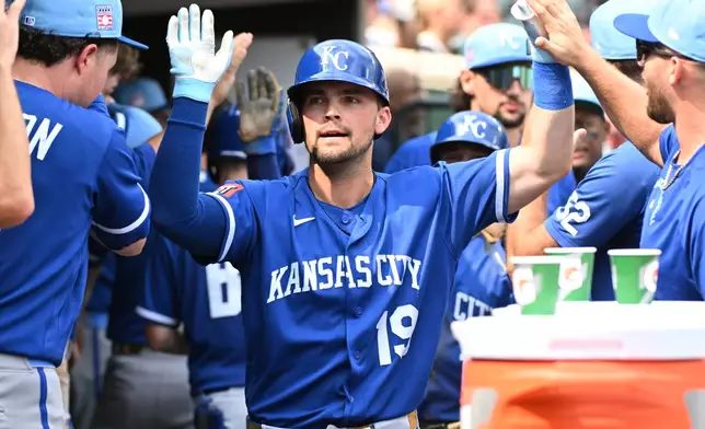 Kansas City Royals' Michael Massey (19) is congratulated by teammates after hitting a two-run home run during the eighth inning of a baseball game against the Detroit Tigers, Sunday, July 26, 2026, in Detroit. (AP Photo/Jose Juarez)