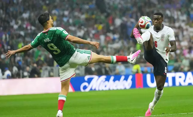 Mexico's Raul Jimenez, left, and England's Marc Guehi challenge for the ball during the World Cup round of 16 soccer match between Mexico and England in Mexico City, Sunday, July 5, 2026. (AP Photo/Moises Castillo)