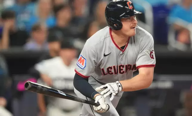 Cleveland Guardians' Kyle Manzardo (9) hits a single during the fifth inning of a baseball game against the Miami Marlins, Saturday, July 11, 2026, in Miami. (AP Photo/Jim Rassol)