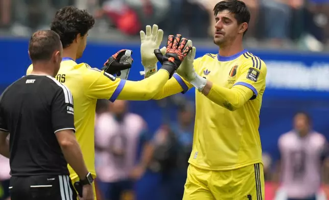 Belgium goalkeeper Thibaut Courtois, right, leaves the pitch after sustaining an injury during the World Cup quarterfinal soccer match between Spain and Belgium in Inglewood, Calif., near Los Angeles, Friday, July 10, 2026. (AP Photo/Andre Penner)