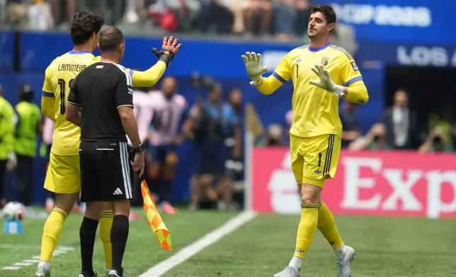 Belgium goalkeeper Thibaut Courtois, right, leaves the pitch after sustaining an injury during the World Cup quarterfinal soccer match between Spain and Belgium in Inglewood, Calif., near Los Angeles, Friday, July 10, 2026. (AP Photo/Andre Penner)