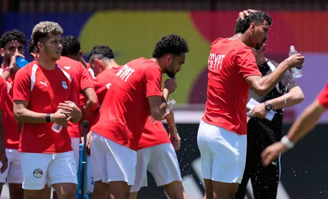 Egypt players hydrate and cool down as the weather nears triple digits during a training session in Dallas, Thursday, July 2, 2026, ahead of the team's World Cup soccer match against Australia. (AP Photo/Tony Gutierrez)