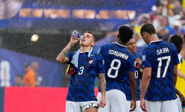 France's Lucas Digne cools during the hydration break during the World Cup round of 32 soccer match between France and Sweden in East Rutherford, N.J., near New York, Tuesday, June 30, 2026. (AP Photo/Seth Wenig)