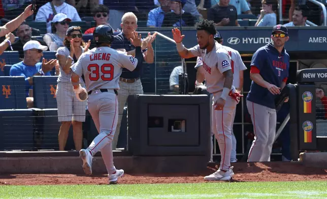 Boston Red Sox's Tsung-Che Cheng (39) and Ceddanne Rafaela, center right, react after Cheng scored on a single hit by Jarren Duran during the ninth inning of a baseball game against the New York Mets, Sunday, July 12, 2026, in New York. (AP Photo/Pamela Smith)