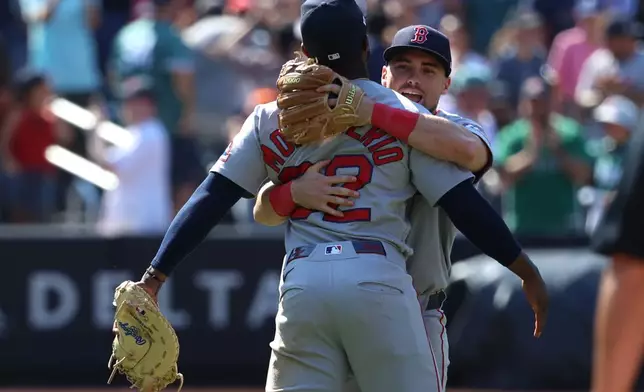 Boston Red Sox's Andruw Monasterio, left, and Caleb Durbin, right, react after winning a baseball game against the New York Mets, Sunday, July 12, 2026, in New York. (AP Photo/Pamela Smith)