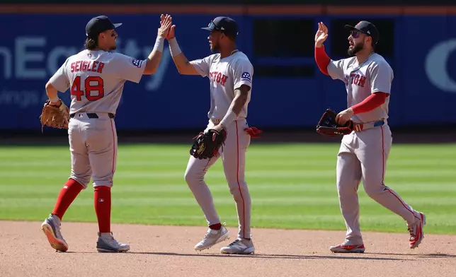 From left to right, Boston Red Sox's Anthony Seigler, Ceddanne Rafaela and Wilyer Abreu react after defeating the New York Mets in a baseball game Sunday, July 12, 2026, in New York. (AP Photo/Pamela Smith)