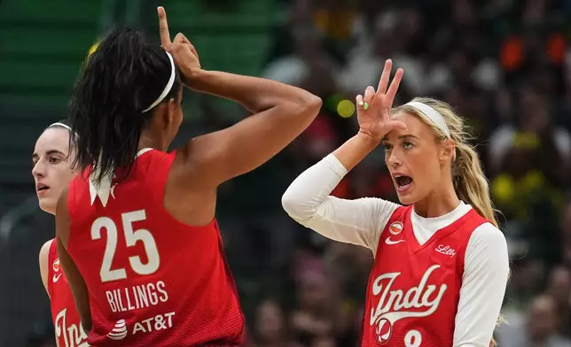Indiana Fever guard Sophie Cunningham (8) reacts to making a basket with teammate Monique Billings (25) during the first half of a WNBA basketball game against the Seattle Storm, Tuesday, July 28, 2026, in Seattle. (AP Photo/Lindsey Wasson)